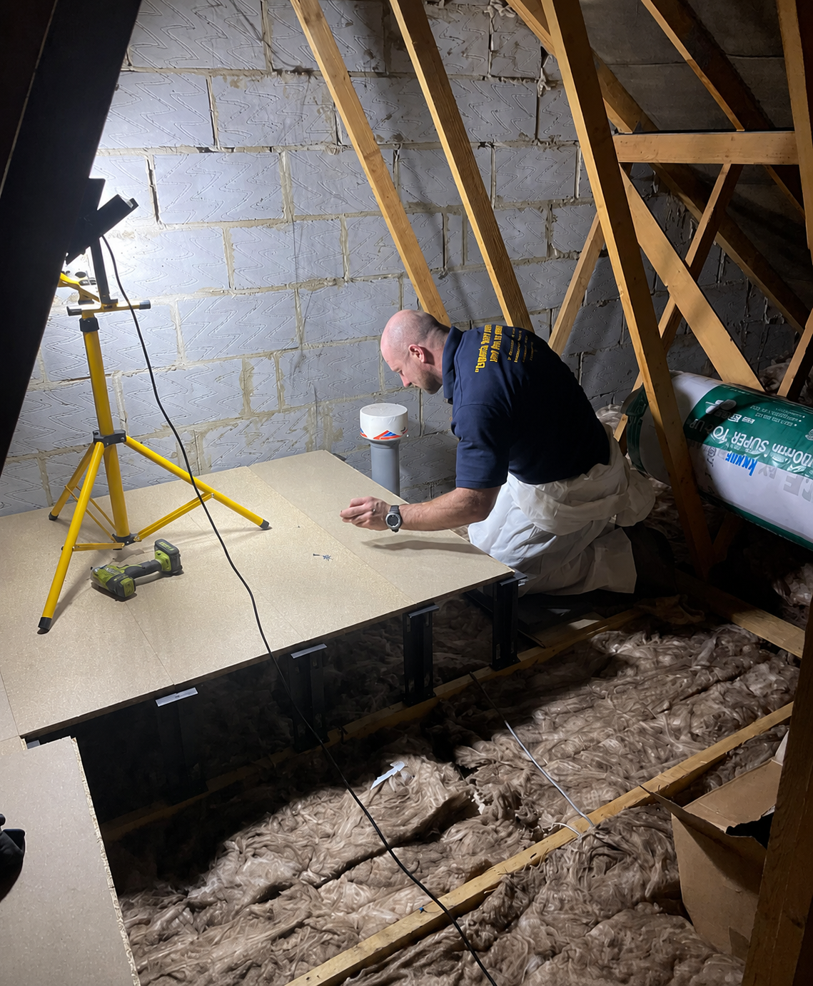 BEEKIND technician installing loft boarding
